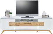 Frontale Ansicht eines modernen TV-Lowboards in Weiß mit Holzdetails, dekoriert mit Pflanzen und Büchern, und einem Fernseher darauf.
