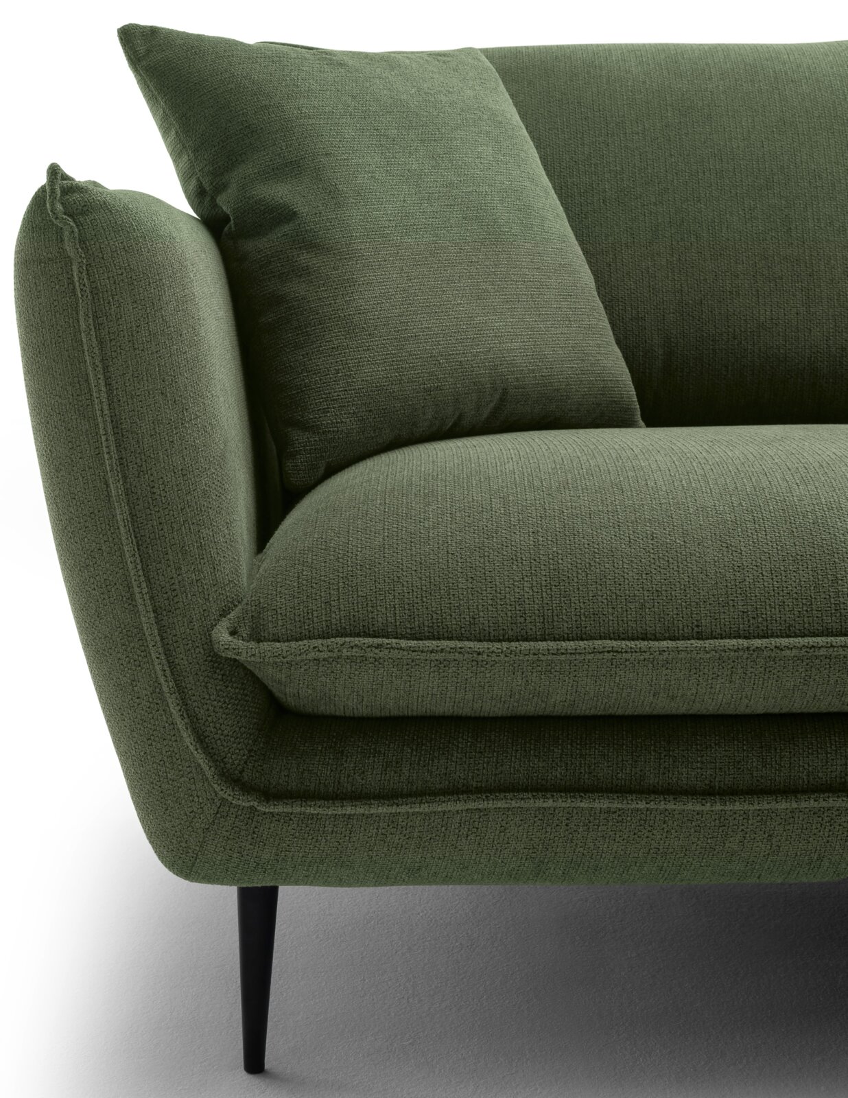 Close-up van een groene ronde hoek met kussens, zijaanzicht