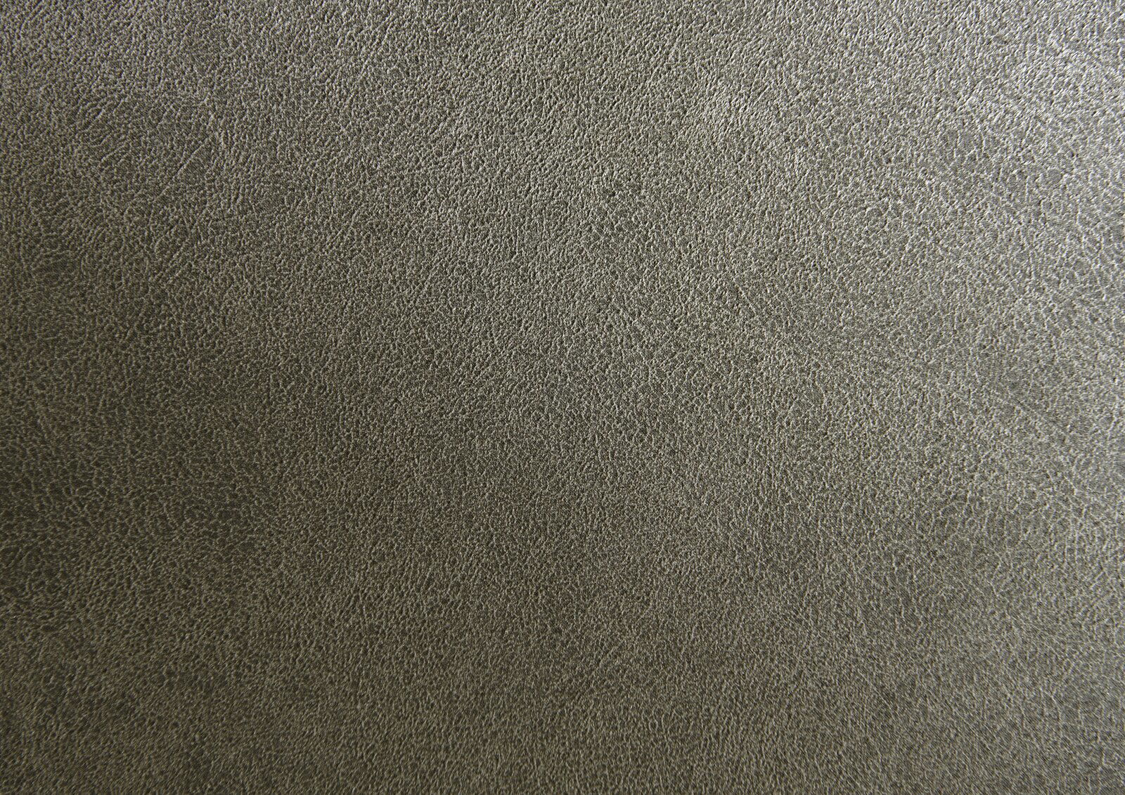 Nahaufnahme einer grauen, strukturierten Polsteroberfläche.