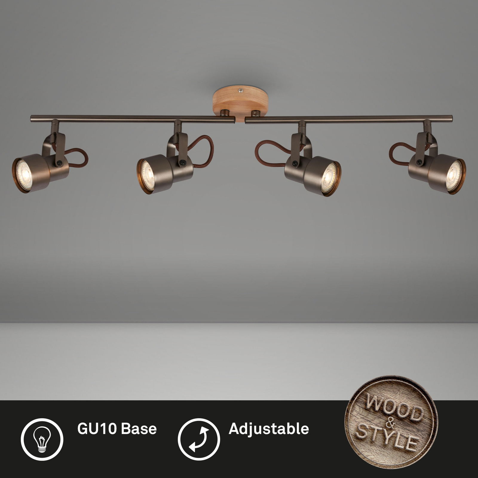 Moderne Spotleuchte mit vier verstellbaren Strahlern und GU10-Fassung, montiert an einer Deckenhalterung aus Holz. Perspektive von unten.