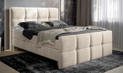 Beige boxspring met gestoffeerd hoofd- en voeteneinde, zijaanzicht