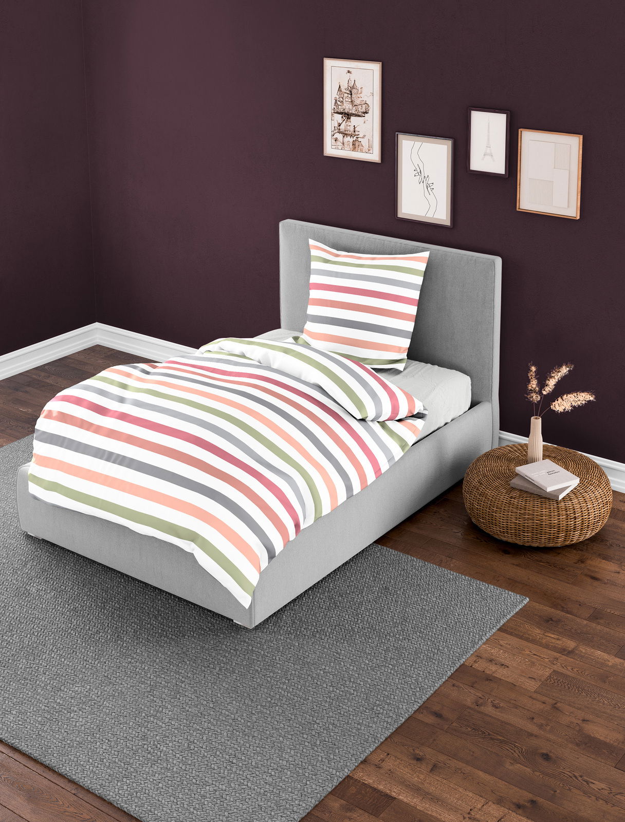 Bettwäsche-Set mit bunten Streifen auf einem grauen Bett in einem modern eingerichteten Schlafzimmer, seitliche Perspektive