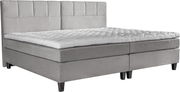 Graues Boxspringbett mit gestepptem Kopfteil und Matratzenauflage, seitliche Perspektive