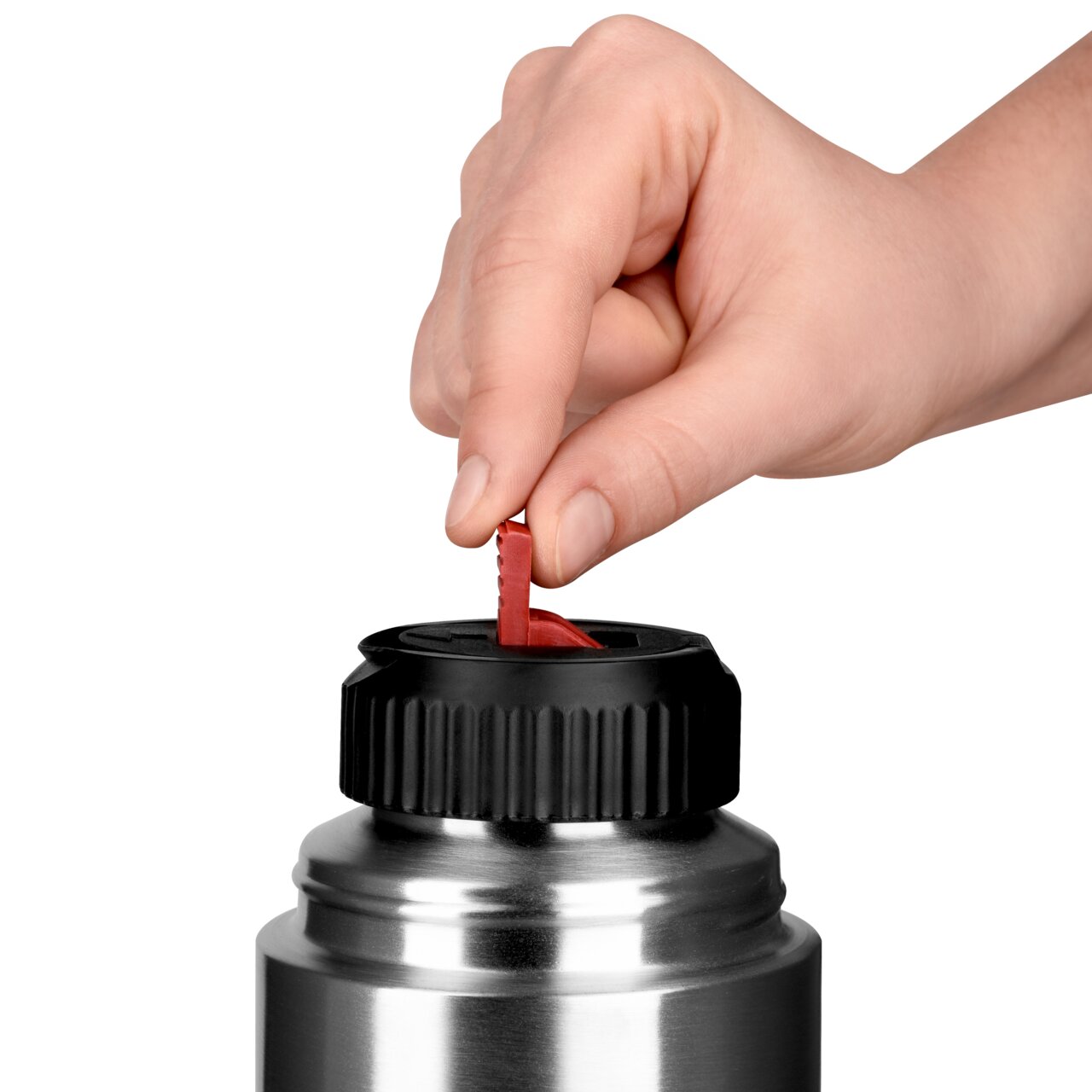 Nahaufnahme einer Hand, die den roten Verschluss einer silbernen Isolierflasche mit schwarzem Deckel öffnet.