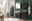 Moderner Badezimmer-Unterschrank in dunklem Holzton, frontal betrachtet, mit stilvollem Waschbecken und grüner Wand im Hintergrund.
