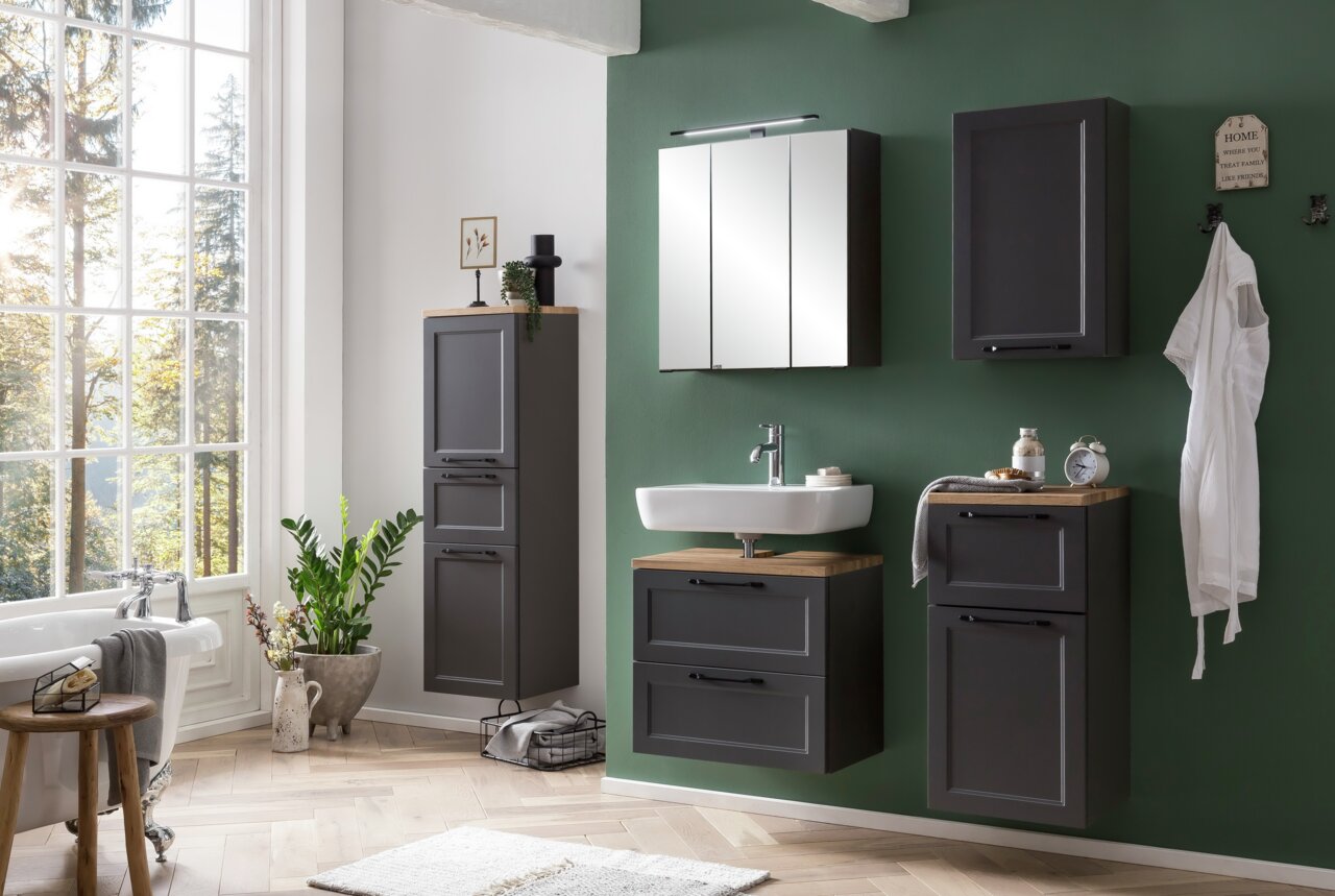 Moderner Badezimmer-Unterschrank in dunklem Holzton, frontal betrachtet, mit stilvollem Waschbecken und grüner Wand im Hintergrund.