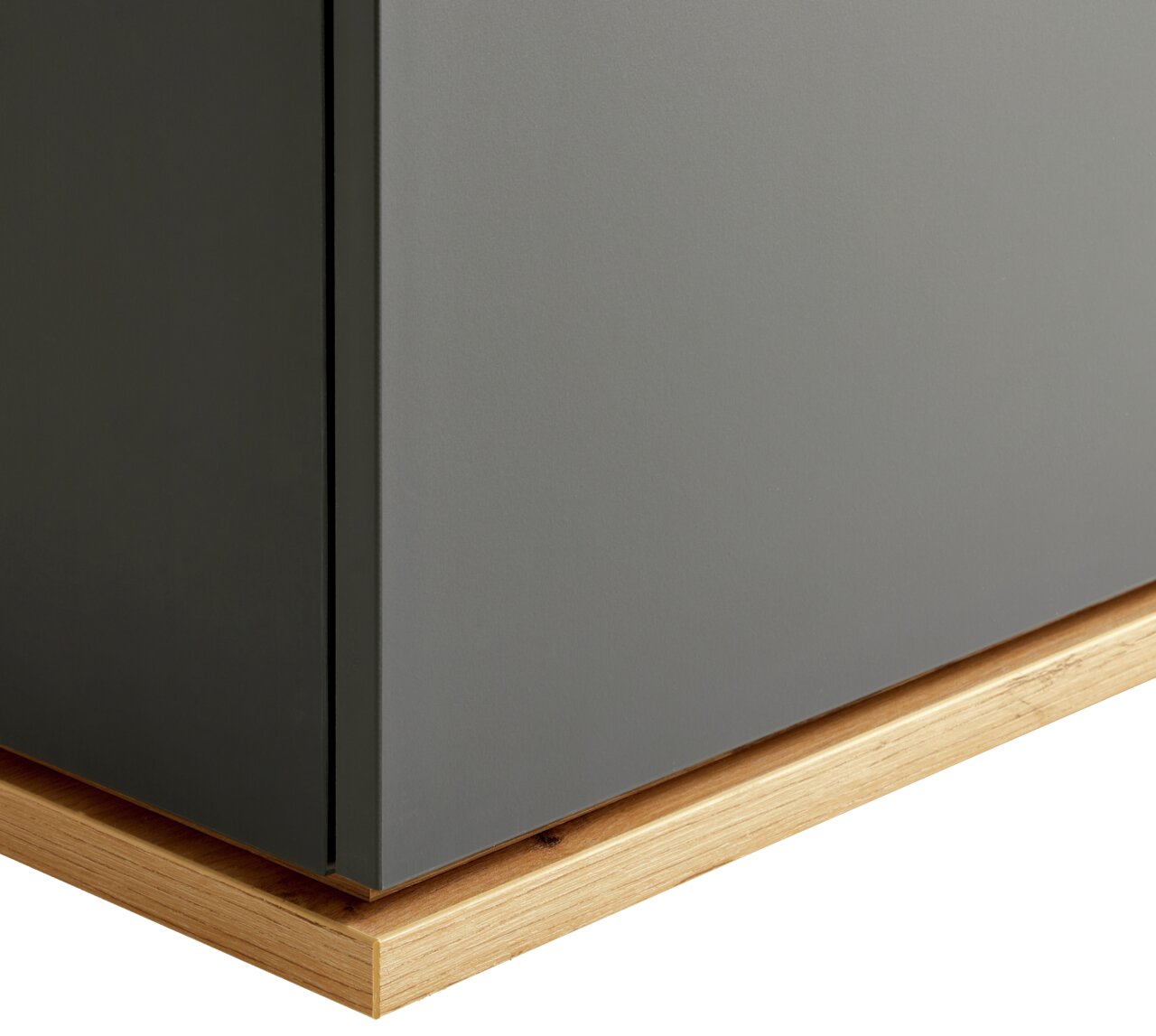 Nahaufnahme einer Kommode mit grauer Oberfläche und hölzerner Basis, seitliche Perspektive