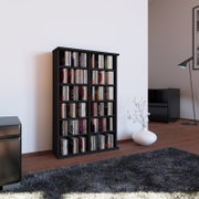 Schwarzes CD/DVD-Regal mit mehreren Fächern, gefüllt mit CDs, in modernem Wohnzimmer auf Holzboden; Perspektive: leicht seitliche Frontansicht auf Augenhöhe.