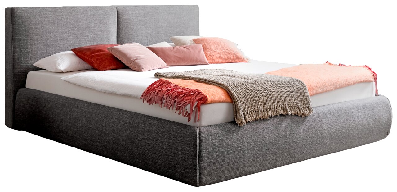 Graues Polsterbett in seitlicher Perspektive mit Kopfteil, dekoriert mit Kissen und Decken in Rosa- und Beigetönen.