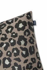 Zierkissenhülle mit Leopardenmuster in Nahaufnahme, perspektivisch von der Ecke fotografiert.