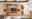 Wandkombination aus Holz mit Glasvitrinen, TV-Schrank und Regalen, frontal betrachtet.