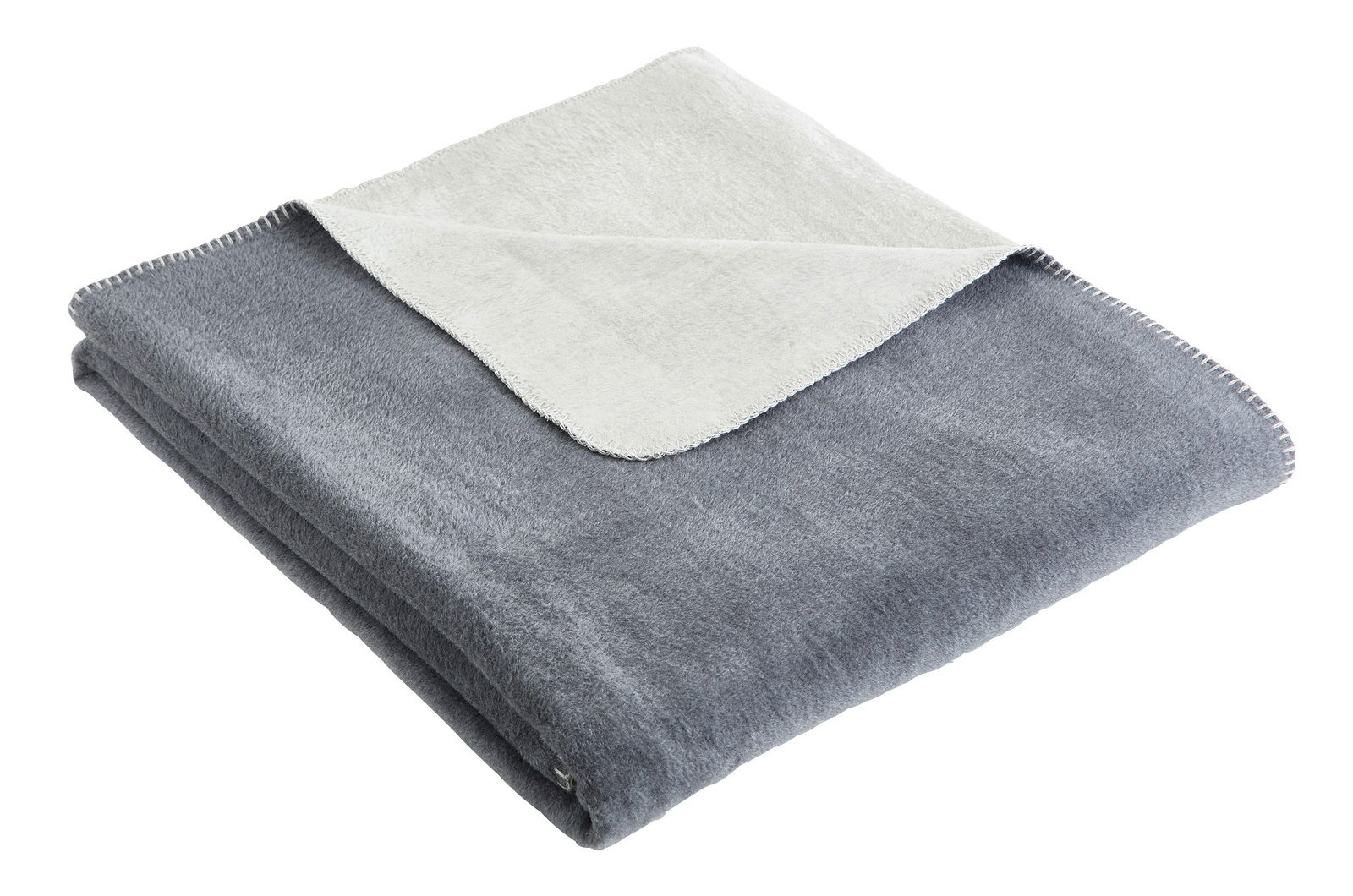 Linneweber Wohndecke BRAGA Gefaltete graue Wohndecke mit heller Rückseite, von schräg oben fotografiert.