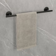 Badetuchstange Uno 60 cm in Schwarz, montiert an einer grauen Wand, mit einem grauen Handtuch. Perspektive: Frontalansicht.