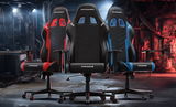 Drei Gaming-Stühle der Marke DX Racer PRINCE in den Farben Rot, Schwarz und Blau, frontal in einer industriellen Umgebung präsentiert.