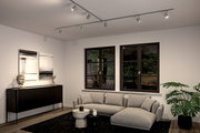 Moderne Wohnzimmeransicht mit PAULMANN Schienenspot Luxe URAIL an der Decke, beleuchtet eine stilvolle Einrichtung mit grauem Sofa, schwarzem Sideboard und großen Fenstern.
