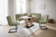 Moderne Esszimmer-Eckbankgruppe mit grünem Stoffbezug und Holztisch in einem hellen Raum, seitliche Perspektive.