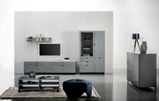 Moderne Wohnzimmermöbel in grauem Design, bestehend aus einem TV-Lowboard, einer Vitrine, einem Couchtisch und einem Sideboard, aus frontaler Perspektive.