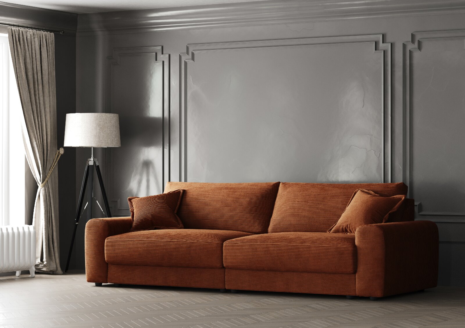 Z2 Big Sofa NAPOLI Großes, gemütliches Big-Sofa in warmem Braunton, frontal fotografiert, mit zwei passenden Kissen, vor einer eleganten grauen Wand mit Zierleisten und neben einem modernen Stehlampe.