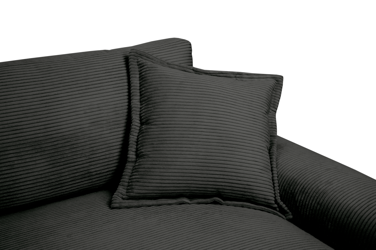 Nahaufnahme eines dunkelgrauen Big-Sofas mit geripptem Stoffbezug und passendem Kissen, seitliche Perspektive.
