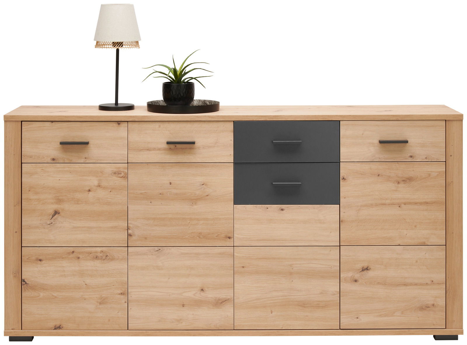 Frontale Ansicht eines modernen Sideboards aus Holz mit zwei dunklen Schubladen, dekoriert mit einer Tischlampe und einer Pflanze.