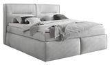 Graues Boxspringbett mit Kopfteil, seitlicher Blickwinkel