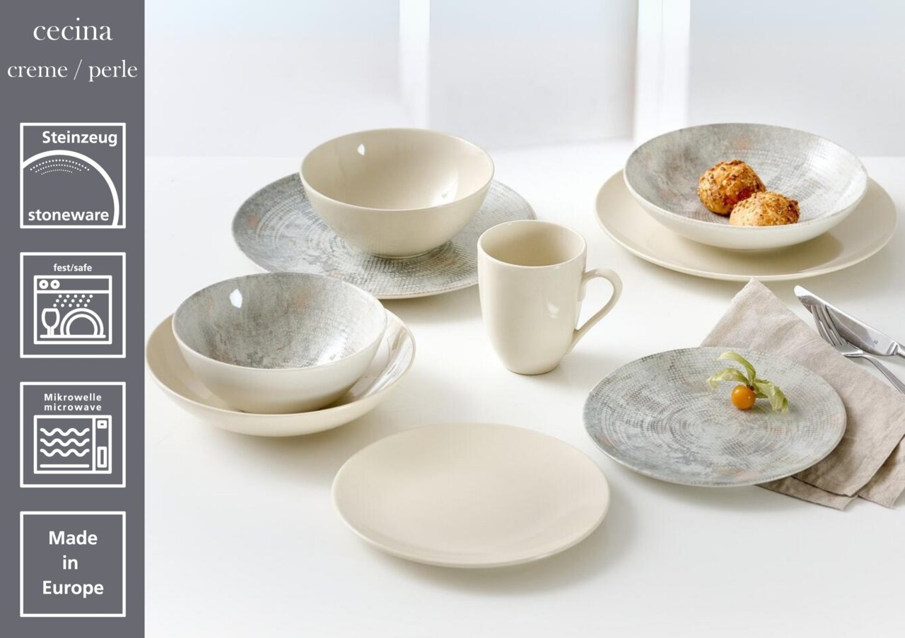 Flacher Teller 26 cm in Creme/Perle aus Steinzeug, präsentiert in einer Tischszene mit anderen Geschirrteilen, seitliche Perspektive.