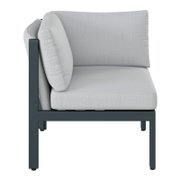Seitenansicht eines Lounge-Ecksofas mit hellgrauen Kissen und einem dunklen Metallrahmen.