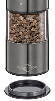 Nahaufnahme einer Pfeffermühle aus Edelstahl mit transparentem Behälter, gefüllt mit Pfefferkörnern, und abnehmbarem Deckel.