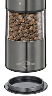 Nahaufnahme einer Pfeffermühle aus Edelstahl mit transparentem Behälter, gefüllt mit Pfefferkörnern, und abnehmbarem Deckel.