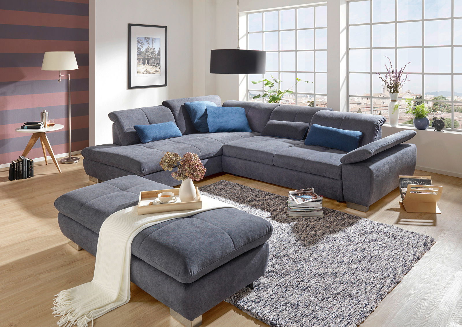 Gemütliche Polsterrundecke in modernem Wohnzimmer mit Hocker, aus der Perspektive von vorne links fotografiert.