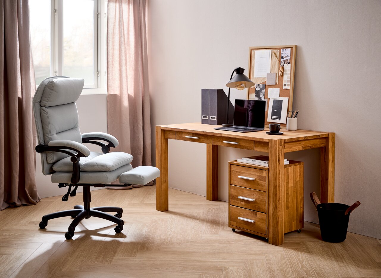 Moderner Schreibtisch aus Holz mit Schubladen, Laptop und Schreibtischlampe, seitliche Perspektive