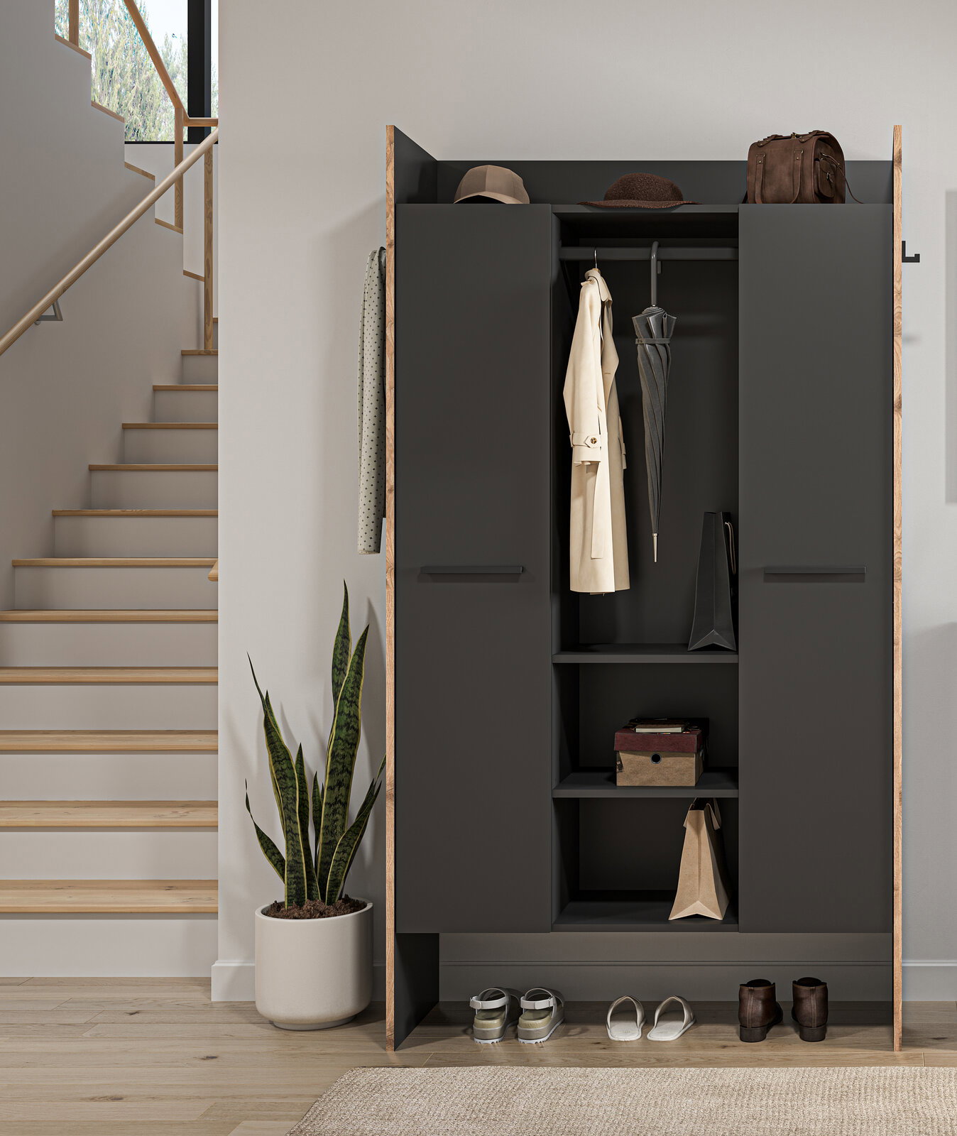 Moderner Garderobenschrank in Anthrazit mit Holzrahmen, geöffnet mit Mantel, Schirm und Ablagen, frontale Ansicht im Flur neben Treppe und Zimmerpflanze.