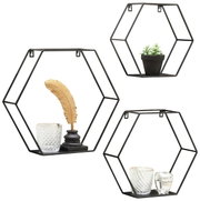 Driedelige wandrek-set in zeshoekige vorm van zwart metaal, versierd met glazen potten, een gouden veer en een klein plantje, gezien van voren.