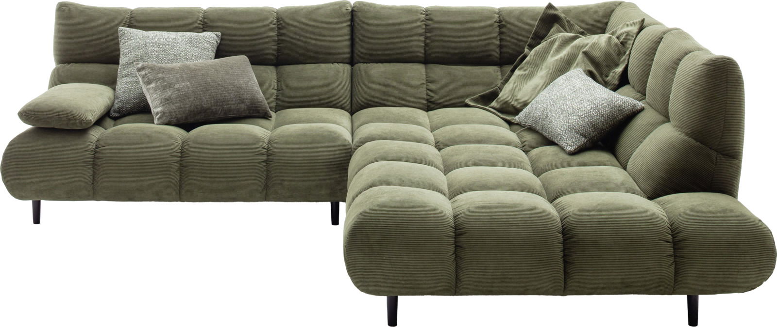 Grüne Eckgarnitur mit Kissen, aus einer leicht erhöhten Perspektive fotografiert.