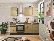 Moderner Küchenblock in Holzoptik ohne Elektrogeräte, frontal fotografiert, mit weißen Backsteinwänden und dekorativen Pflanzen.