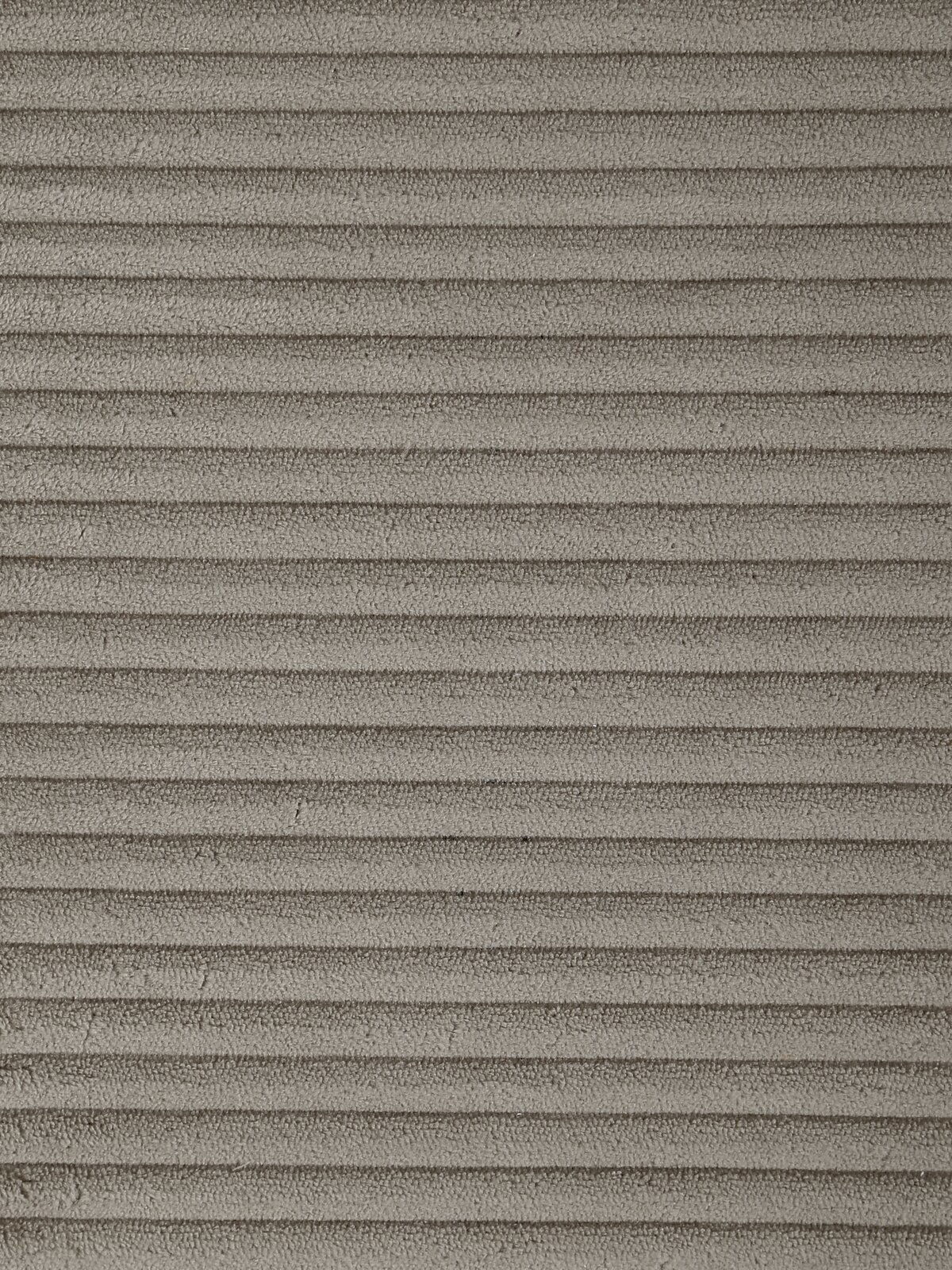 Nahaufnahme eines grauen, gerippten Stoffes, der für einen Schwingstuhl verwendet wird, aus der Vogelperspektive.