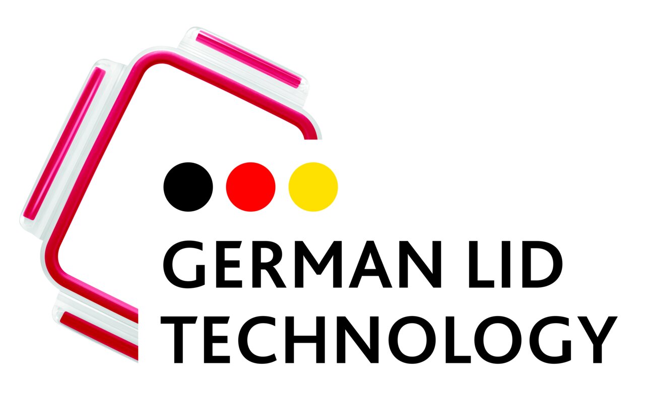 Close-up van een rechthoekig glazen deksel met een rode rand en het opschrift 'German Lid Technology'.