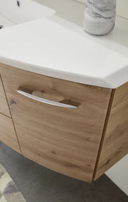 Nahaufnahme einer Badkombination mit Holzoptik und weißem Waschbecken, seitliche Perspektive