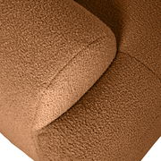 Nahaufnahme einer braunen, texturierten Rundecke aus Stoff, von oben betrachtet.