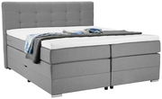 Graues Boxspringbett mit hohem Kopfteil, seitliche Perspektive