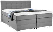 Graues Boxspringbett mit hohem Kopfteil, seitliche Perspektive