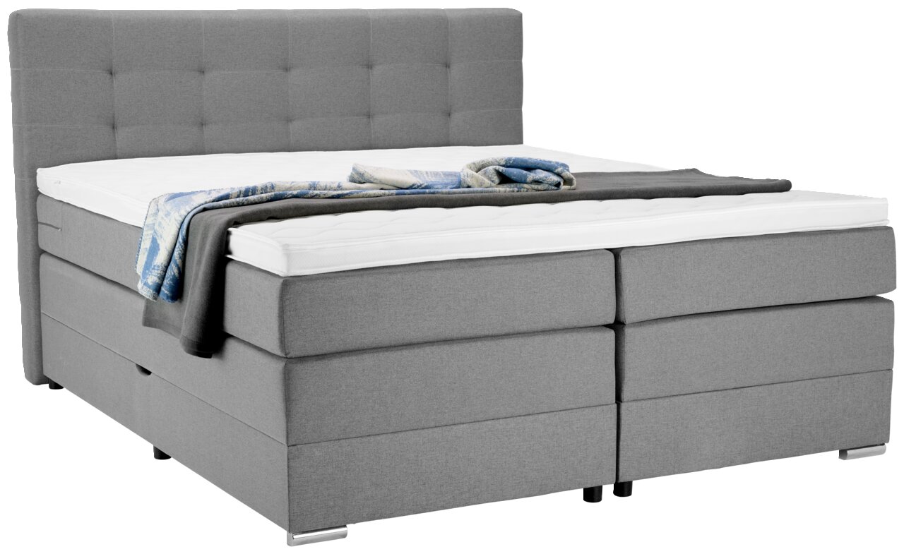 Graues Boxspringbett mit hohem Kopfteil, seitliche Perspektive
