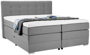 Graues Boxspringbett mit hohem Kopfteil, seitliche Perspektive