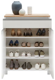 Schuhschrank mit mehreren Regalböden, gefüllt mit verschiedenen Schuhen, aus der Frontalperspektive. Obenauf stehen dekorative Vasen.