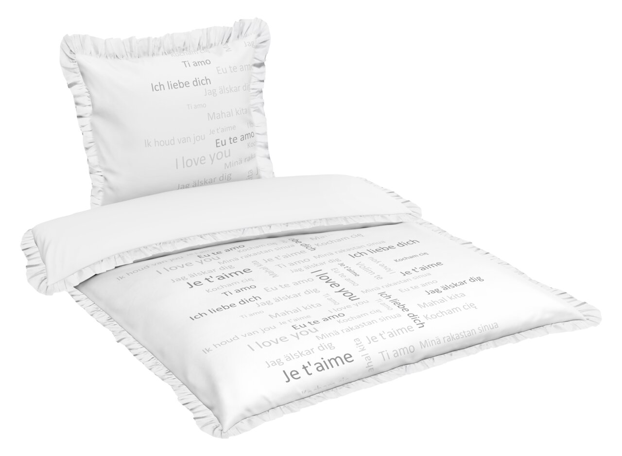 Bettwäsche-Set mit Kissen und Decke, bedruckt mit 'Ich liebe dich' in verschiedenen Sprachen, von schräg oben fotografiert.