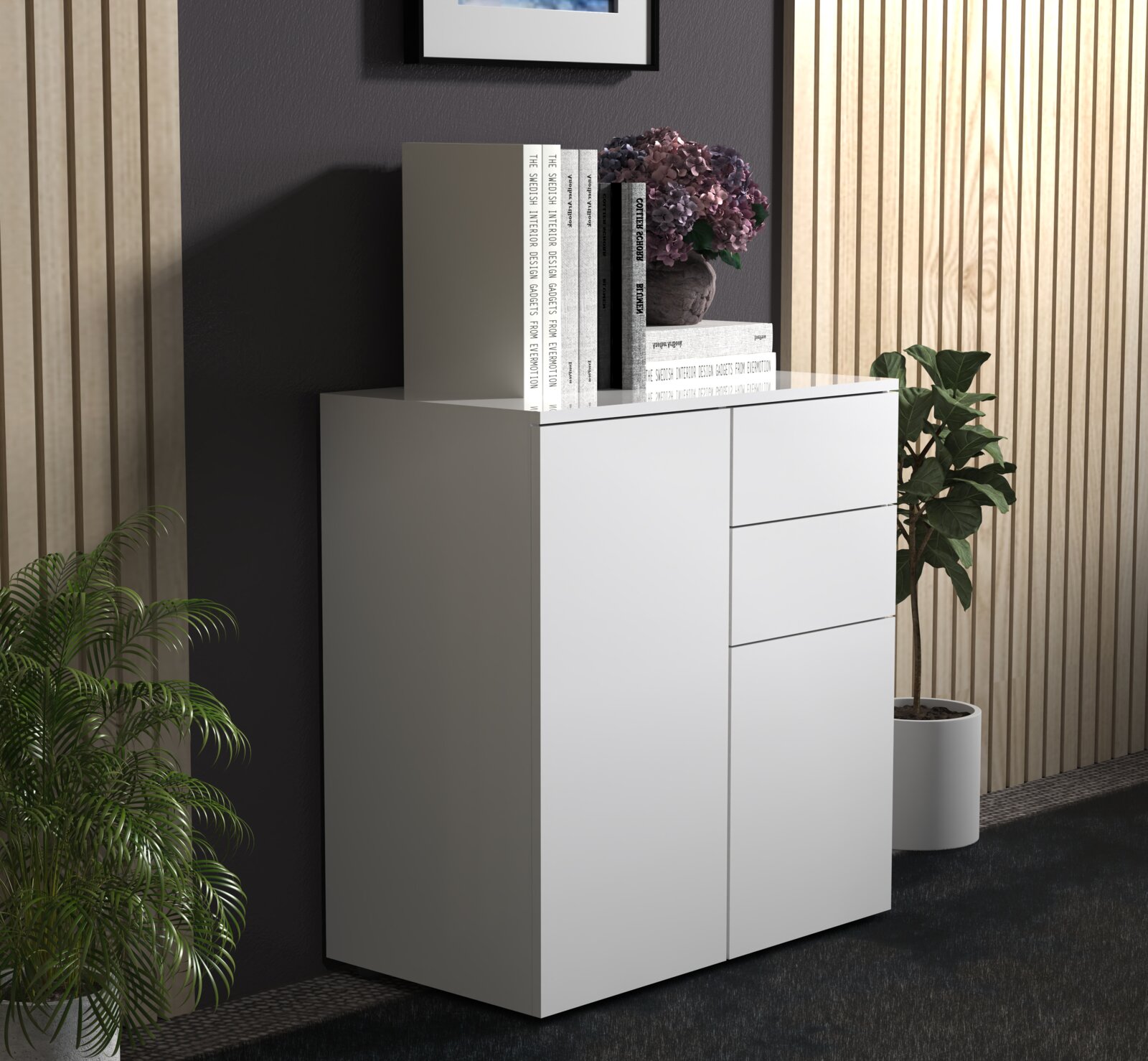Weiße, moderne Kommode mit glatter Front und drei Schubladen in Wohnraum-Inszenierung, mit Büchern und Blumen auf der Ablage; Ansicht schräg von vorn rechts.