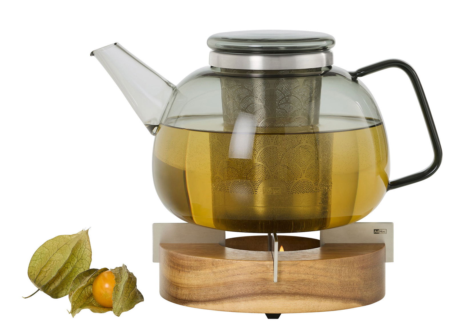 Teekanne mit integriertem Teesieb auf einem Holz-Stövchen, seitliche Perspektive