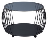 Moderner Couchtisch mit rundem Glasplatte und schwarzem Metallgestell, seitliche Perspektive.