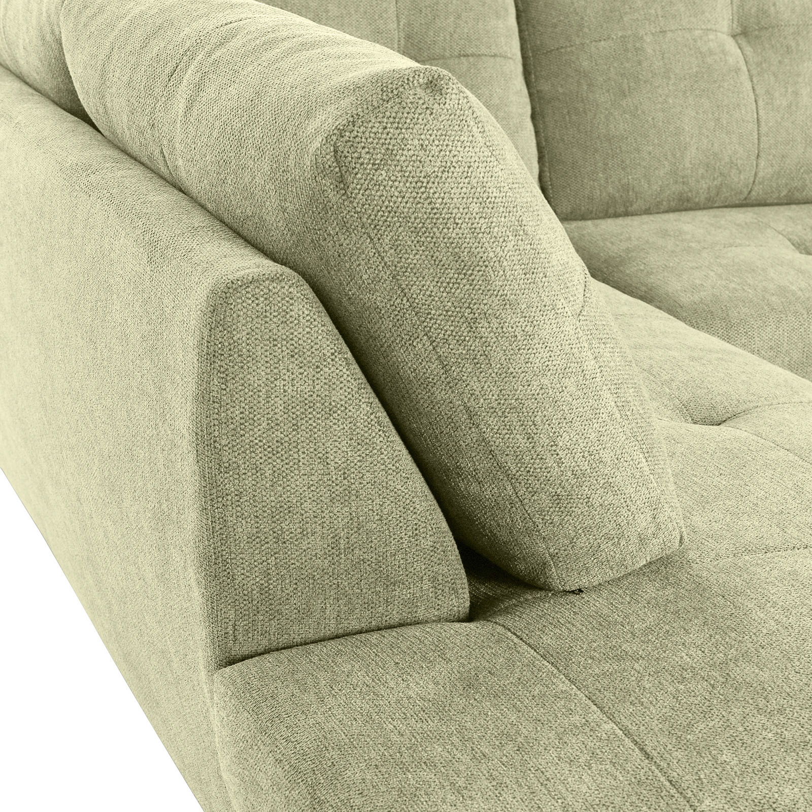 Nahaufnahme einer grünen Sofaecke mit gepolsterten Armlehnen und strukturiertem Stoffbezug, Perspektive von oben.