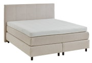 Boxspringbed in beige, gezien vanaf de zijkant